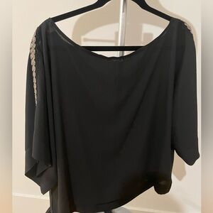 Black chiffon blouse oversize with boat neck or one shoulder.